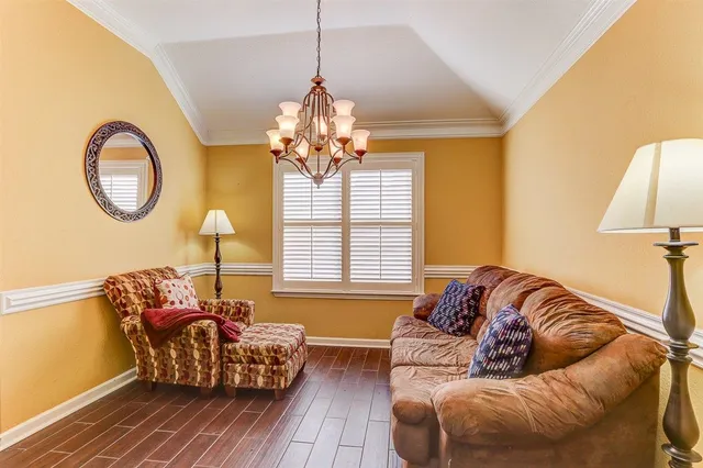 a living room with furniture and a chandelier