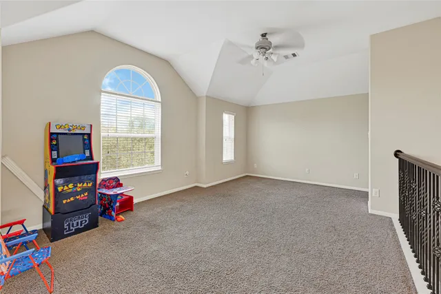 an empty room with toys and dresser