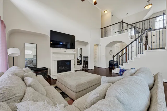 a living room with furniture a flat screen tv and a fireplace
