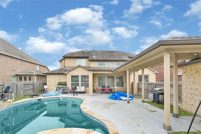 a view of a house with backyard porch and sitting area