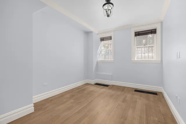 a kitchen with stainless steel appliances granite countertop a stove a sink and white cabinets