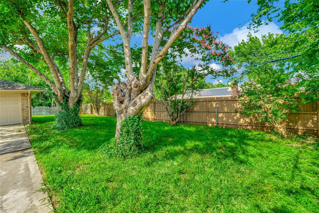 6021 Sycamore Creek Road Edgecliff Village, TX 76134 - Photo 28 of 37 View of yard with a garage and concrete driveway