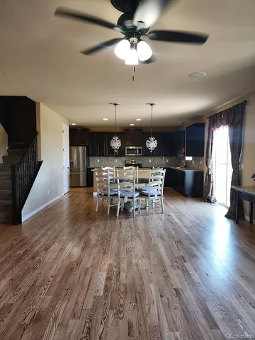 a view of a dining room with furniture wooden floor and chandelier