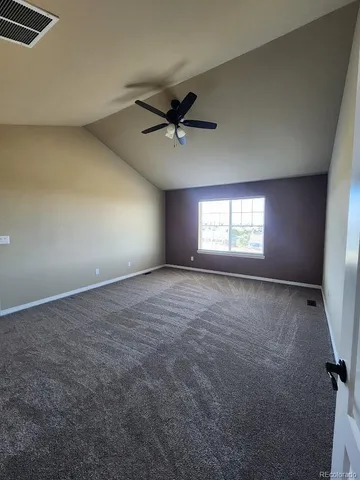 a view of a livingroom with a ceiling fan and window