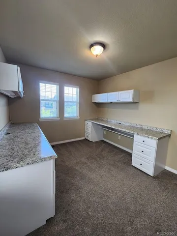 a bathroom with a granite countertop sink a toilet and a shower