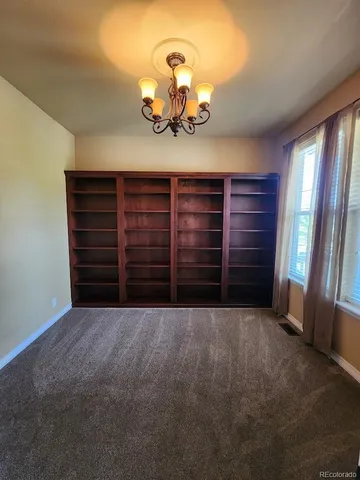 a view of a room with an empty space and window