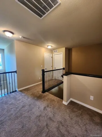 a living room with a bed furniture and a flat screen tv