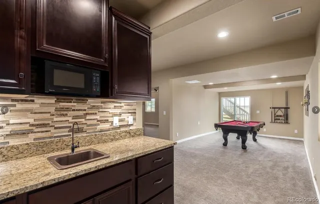a kitchen with granite countertop stainless steel appliances and a counter top space