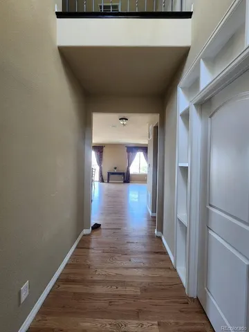 a view of a hallway view with wooden floor