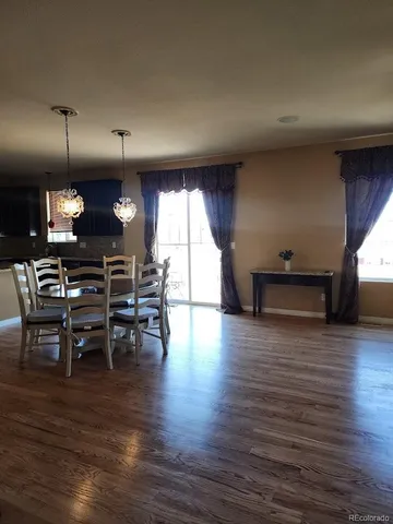 a view of dining room with furniture and wooden floor