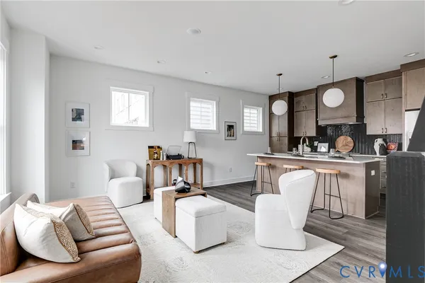 a living room with furniture a rug and white walls