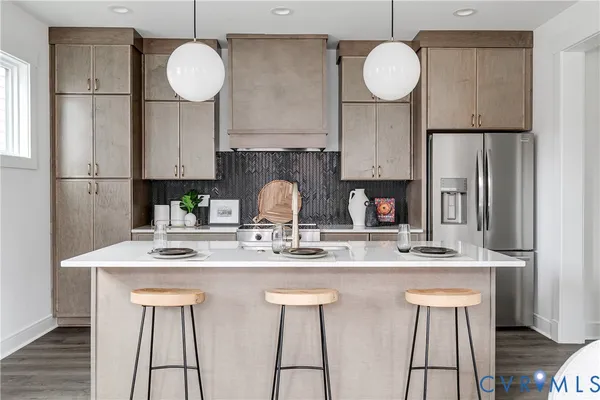 a kitchen with a sink and a stove with white cabinets