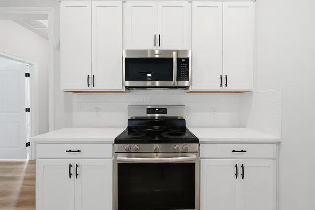 a kitchen with stainless steel appliances a refrigerator sink and cabinets