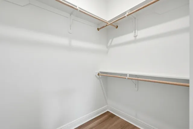 a bedroom with bed and a potted plant