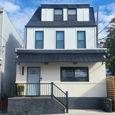 a view of a backyard with table and chairs and a fire pit