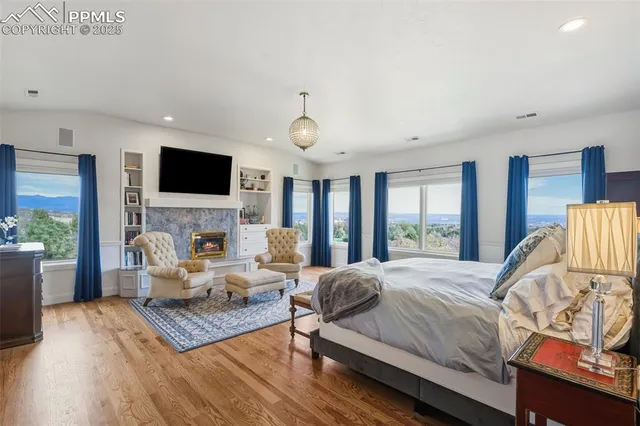 a bathroom with a tub a sink and a large mirror next to a window