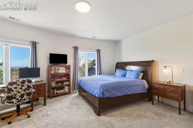 a bedroom with a bed and a large window