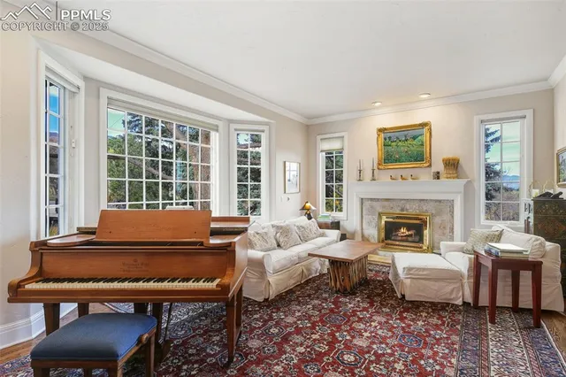 a living room with furniture and a floor to ceiling window