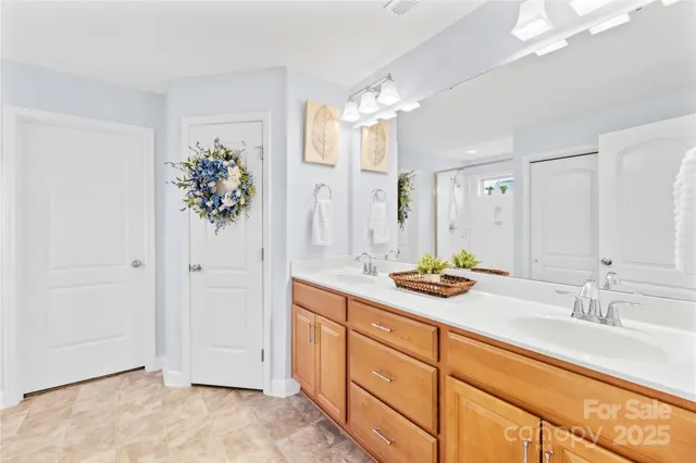 a bedroom with bed a large window and potted plant