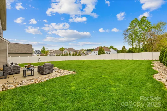 a view of a garden with lawn chairs