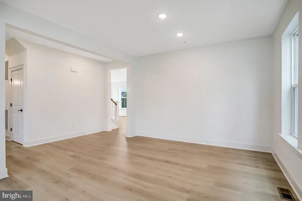 a view of an empty room with a window and fireplace