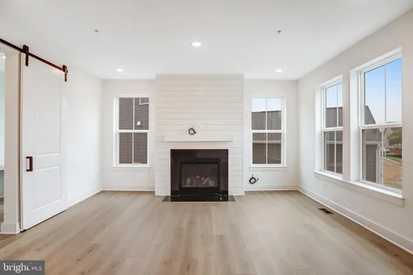 a view of kitchen with wooden floor and electronic appliances