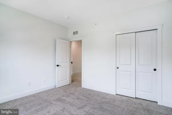 a view of a white house with a small yard and a large window