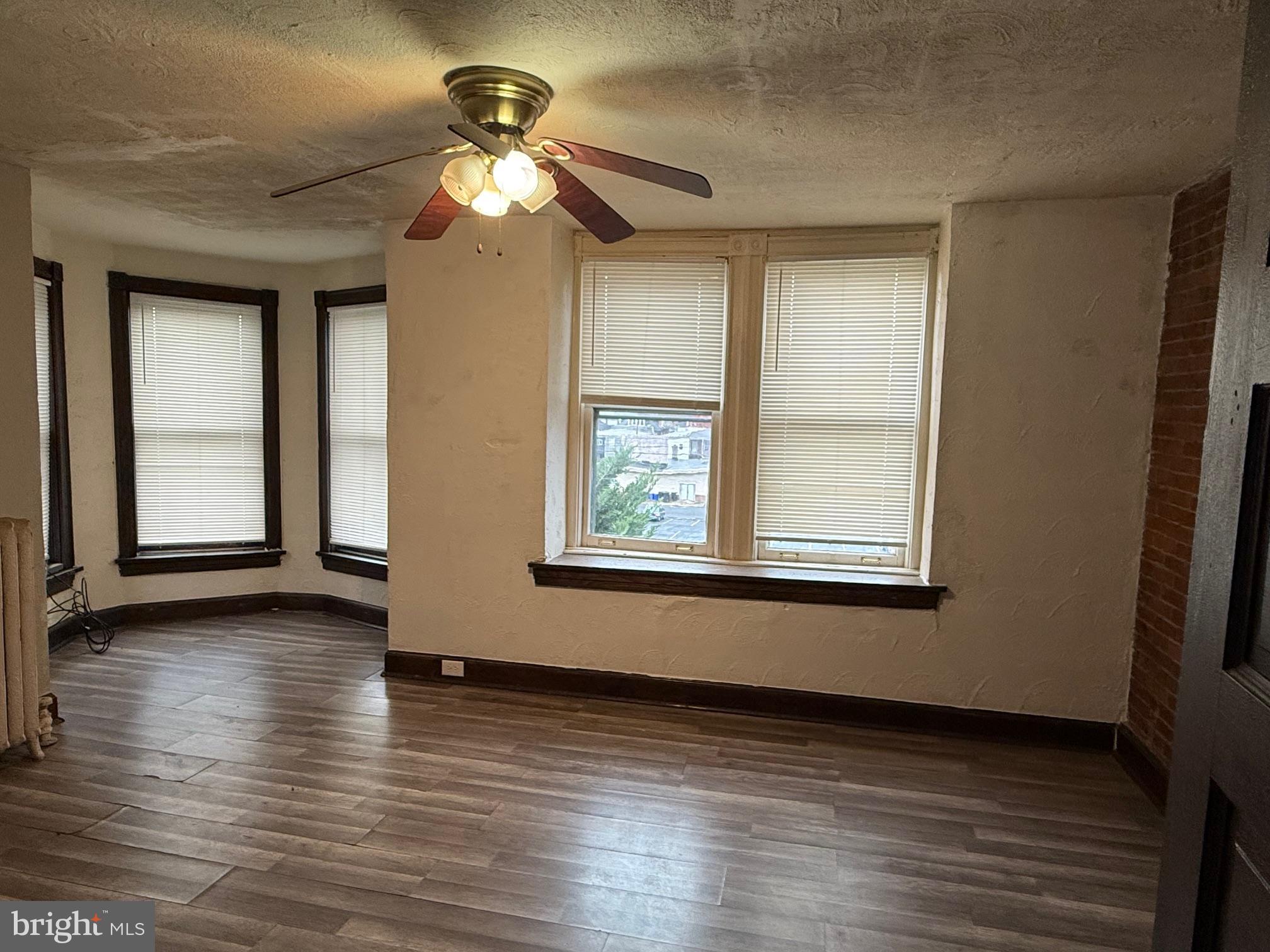 2329 North 3rd Street, Unit 2 Harrisburg, PA 17110 - Photo 13 of 17 a view of an empty room with wooden floor and a window