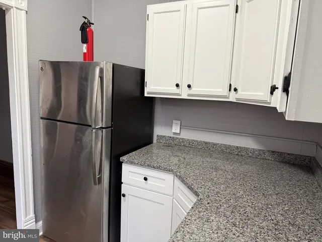 a kitchen with a refrigerator and cabinets