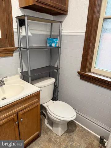 a white toilet sitting next to a bathroom sink