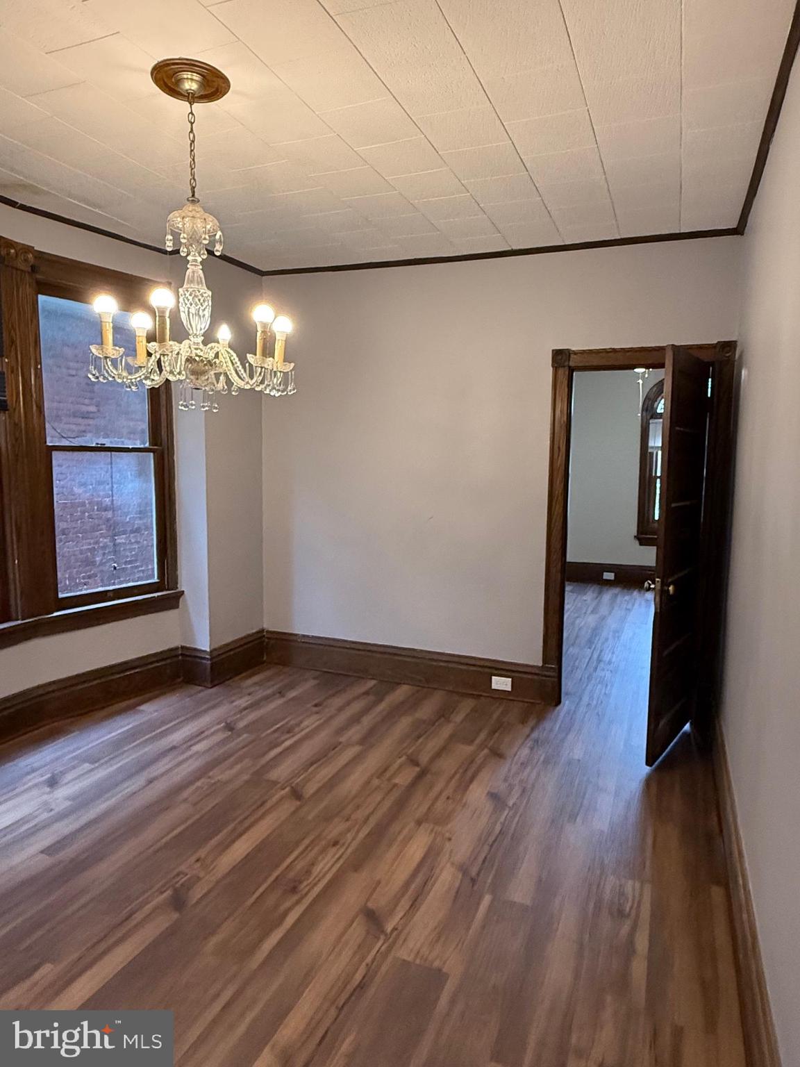 2329 North 3rd Street, Unit 2 Harrisburg, PA 17110 - Photo 7 of 17 a view of a room with wooden floor chandelier and closet