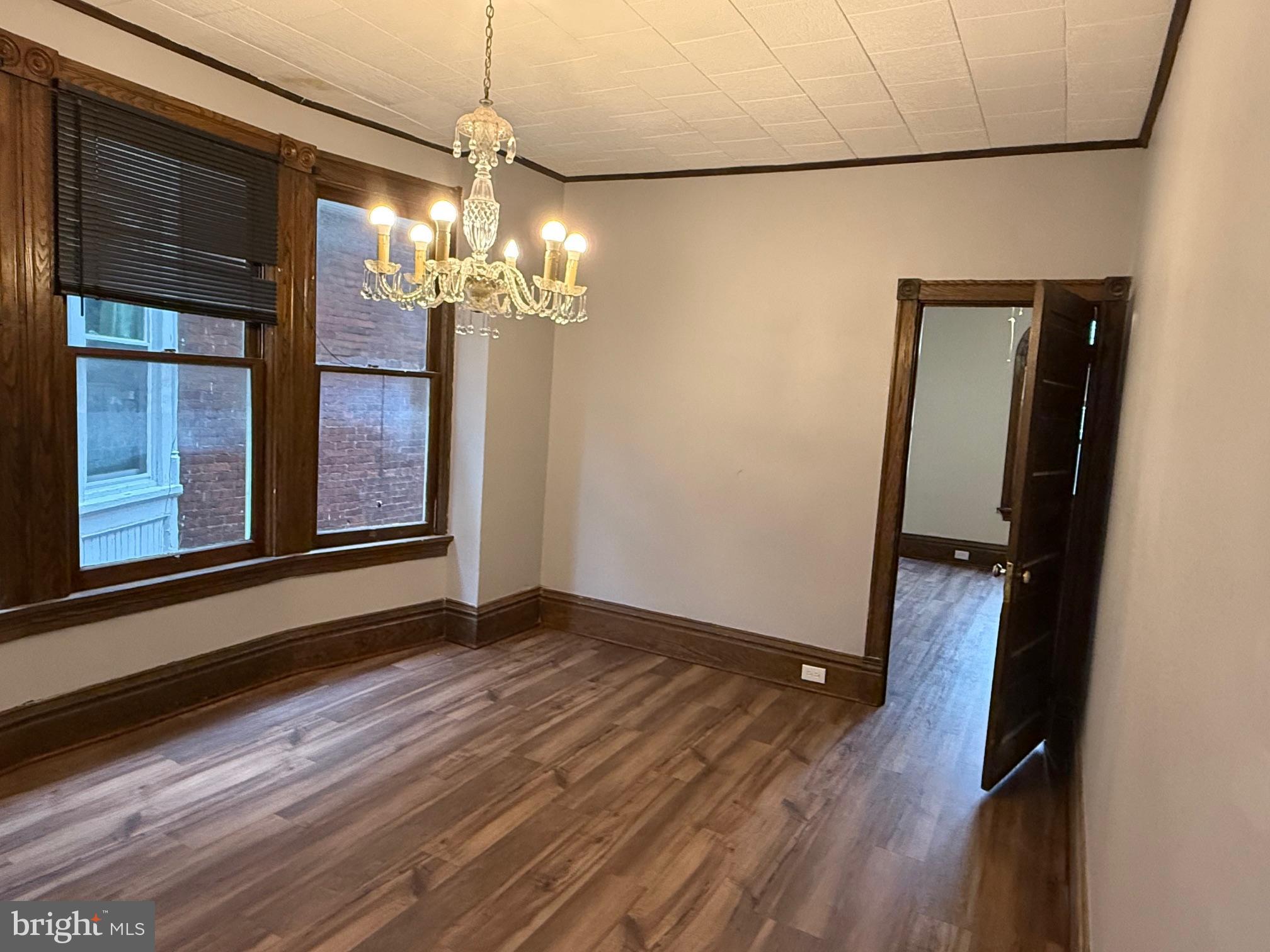 2329 North 3rd Street, Unit 2 Harrisburg, PA 17110 - Photo 8 of 17 a view of a room with wooden floor and chandelier