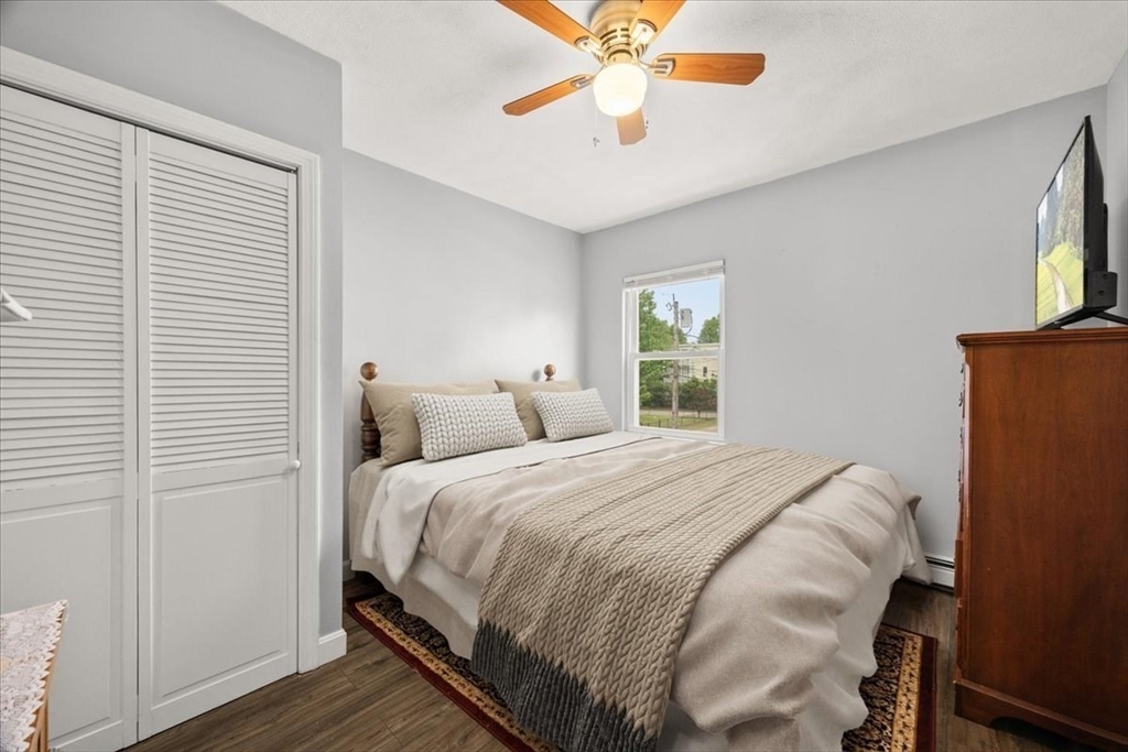 35 Hazel Street, Unit B Attleboro, MA 02703 - Photo 16 of 21 a bedroom with a bed and a chandelier
