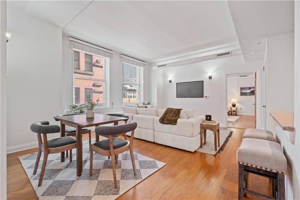 306 Fourth Avenue, Unit 501 Pittsburgh, PA 15222 - Photo 14 of 30 a living room with furniture and a flat screen tv