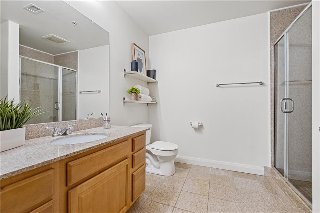 306 Fourth Avenue, Unit 501 Pittsburgh, PA 15222 - Photo 25 of 30 a bathroom with a granite countertop sink a toilet and shower