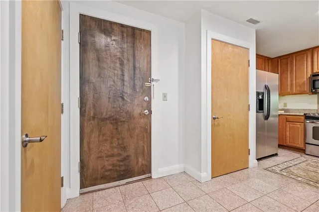 a view of a kitchen with refrigerator and cabinet