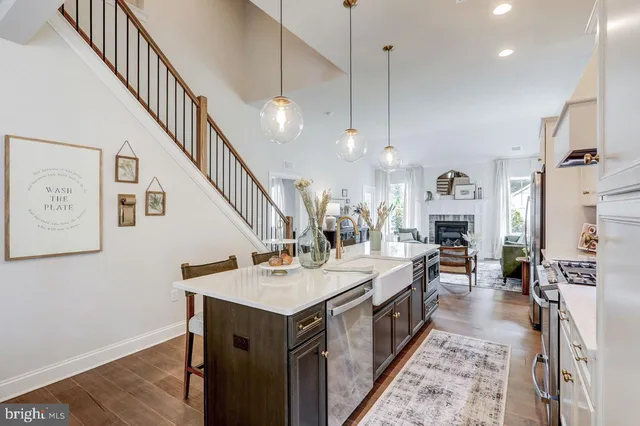 a open kitchen with sink a counter top space and stainless steel appliances