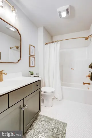 a bathroom with a sink a toilet and bathtub