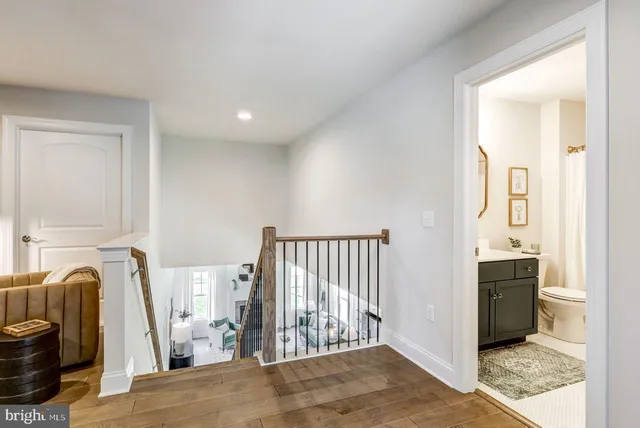 a view of a livingroom with wooden floor and entryway