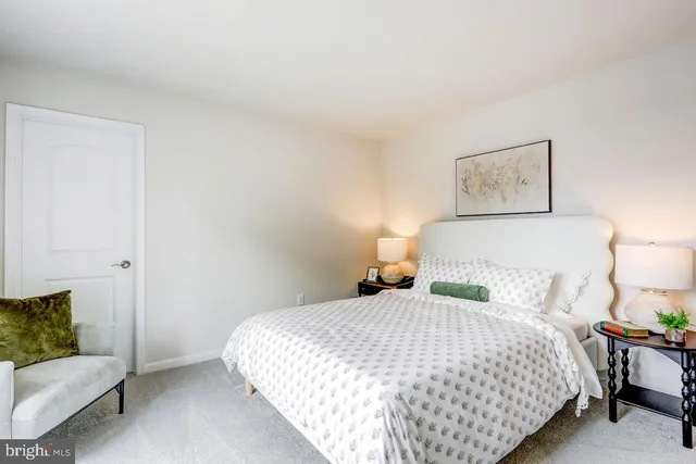 a bedroom with a bed and a couch