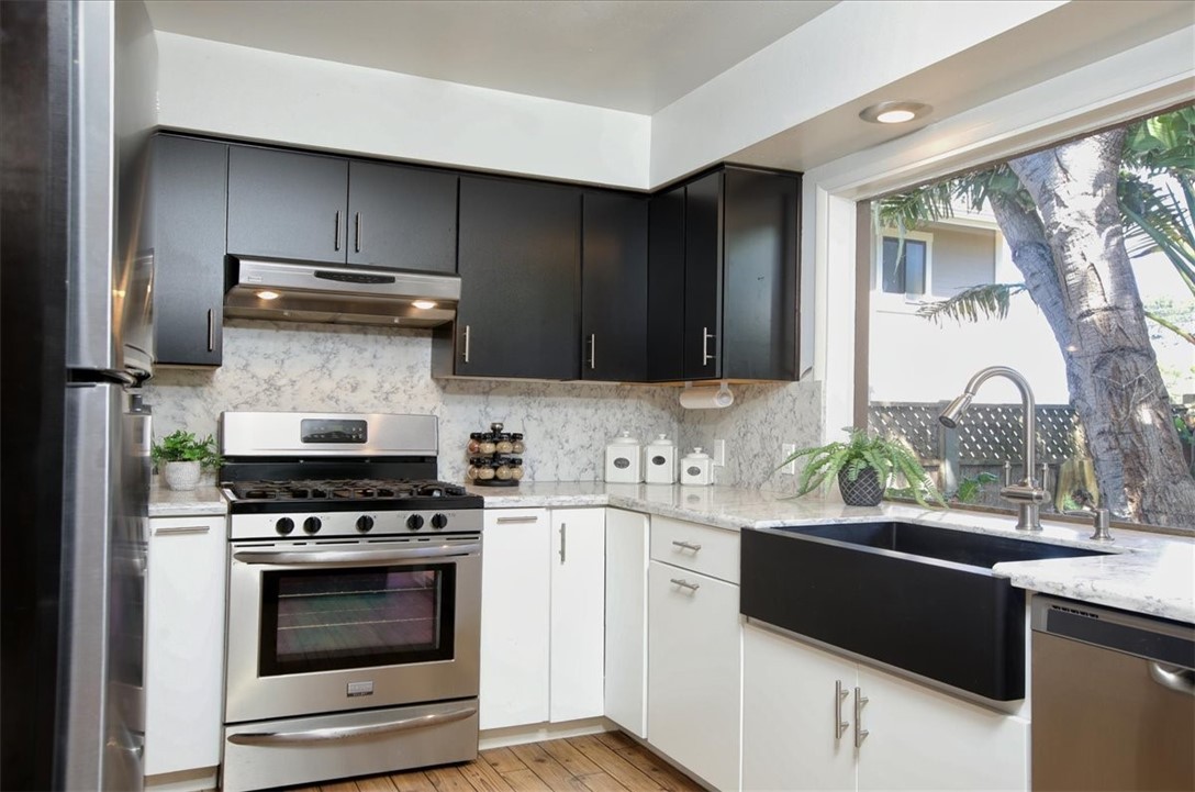 798 Drake Street Cambria, CA 93428 - Photo 13 of 45 a kitchen with a stove a sink and a microwave