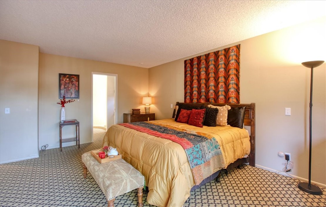 798 Drake Street Cambria, CA 93428 - Photo 24 of 45 a bedroom with a bed and wooden floor