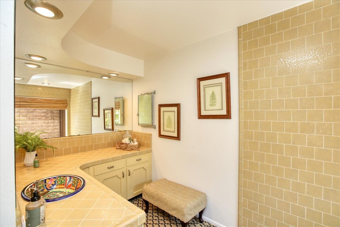 798 Drake Street Cambria, CA 93428 - Photo 26 of 45 a bathroom with a sink a mirror a toilet and a shower