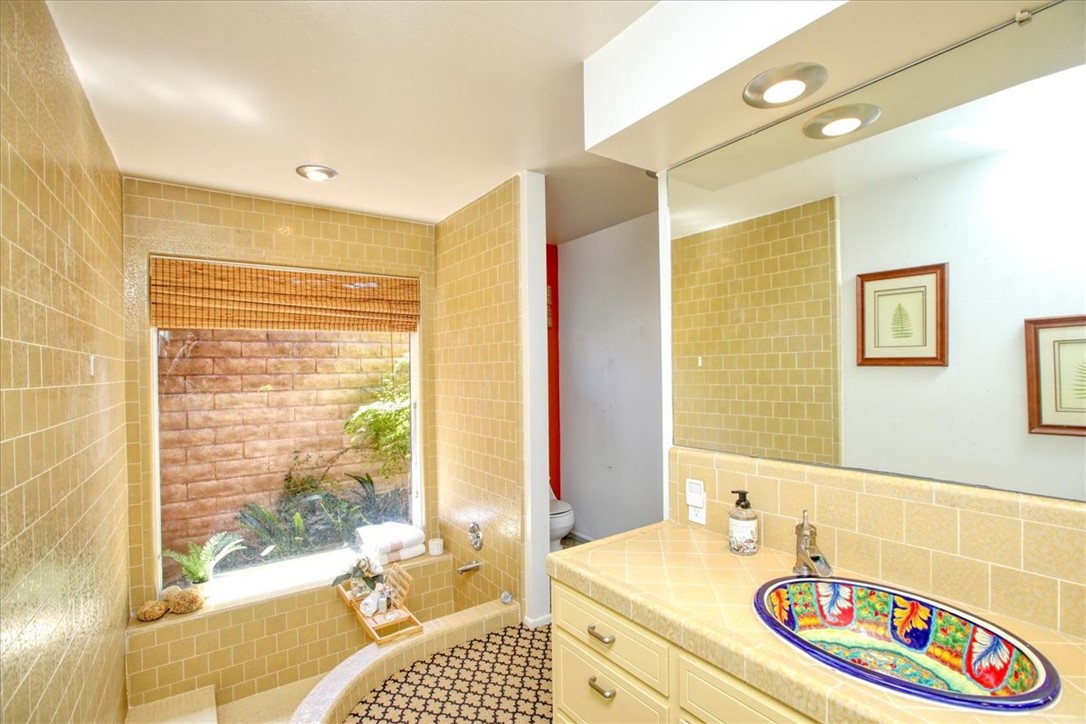 798 Drake Street Cambria, CA 93428 - Photo 27 of 45 a bathroom with a sink double vanity and a shower