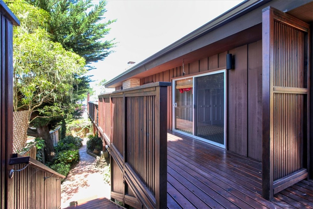 798 Drake Street Cambria, CA 93428 - Photo 33 of 45 a backyard of a house with potted plants and wooden fence
