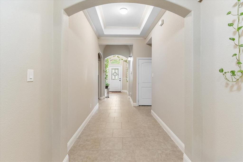 502 Ritchey Street Gainesville, TX 76240 - Photo 5 of 29 a view of a hallway to a livingroom with wooden floor