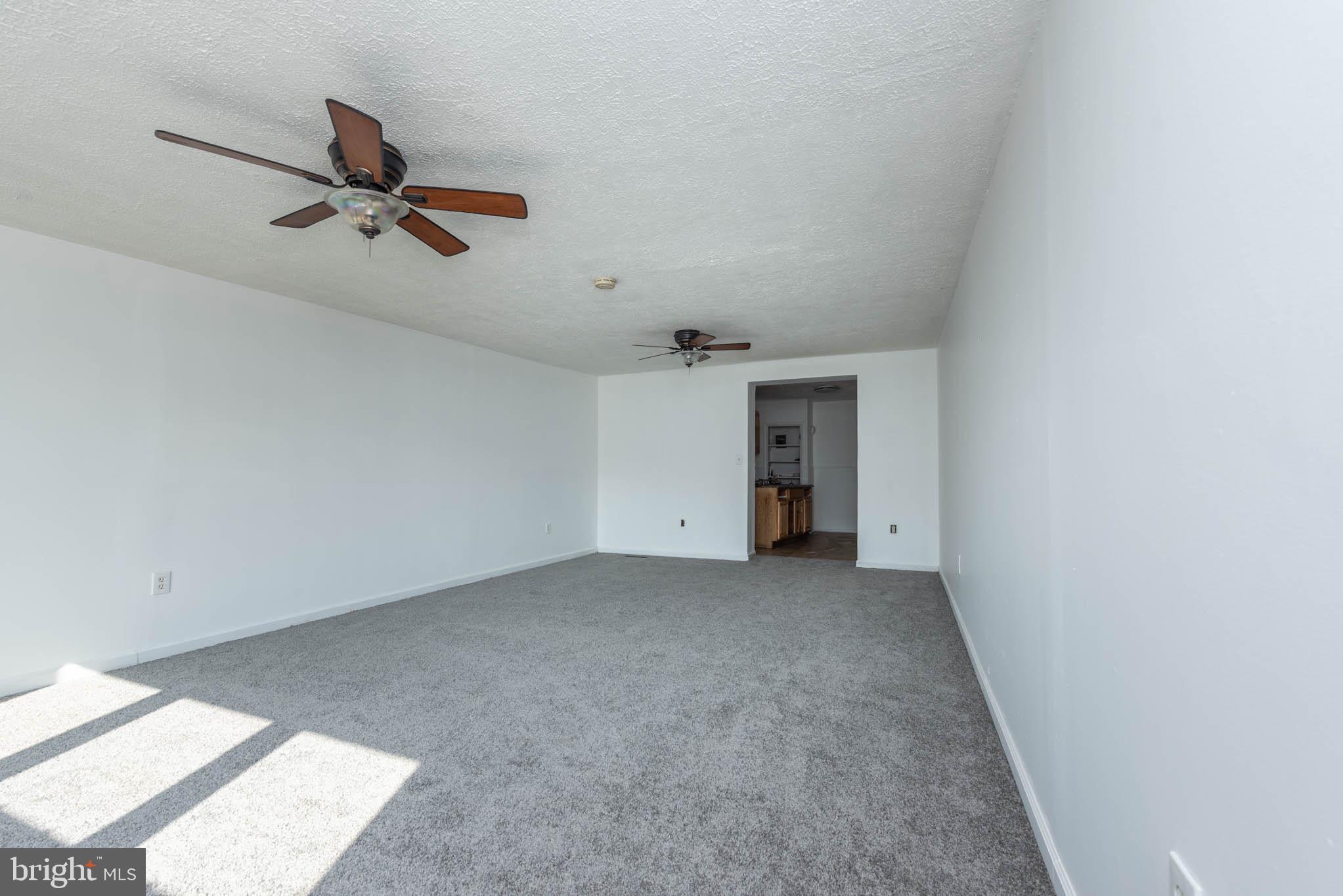 7231 Harford Road Baltimore, MD 21234 - Photo 7 of 21 an empty room with a ceiling fan and window