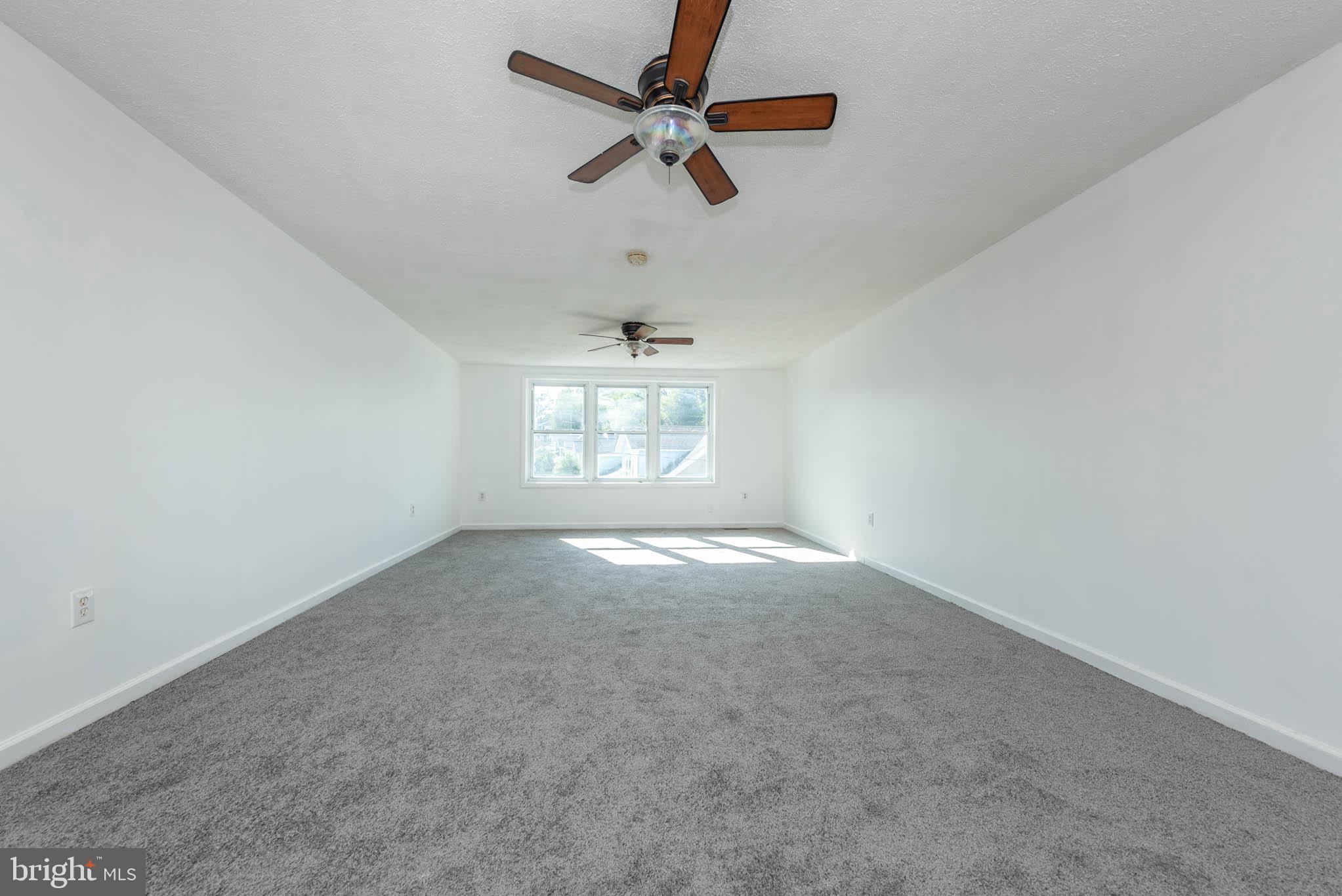 7231 Harford Road Baltimore, MD 21234 - Photo 8 of 21 an empty room with windows and fan