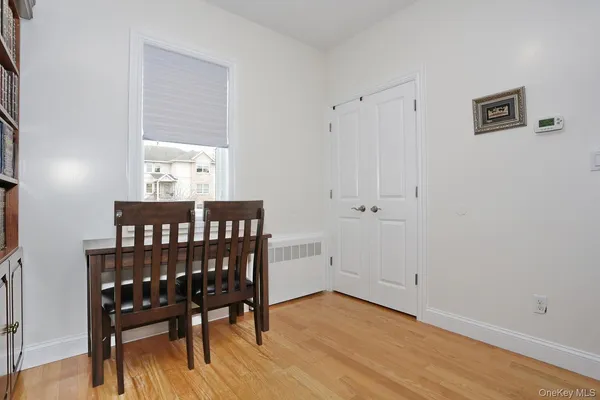 a view of a room with wooden floor lounge chair and windows