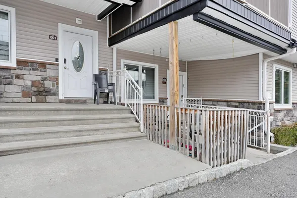 a front view of a house with a stairs